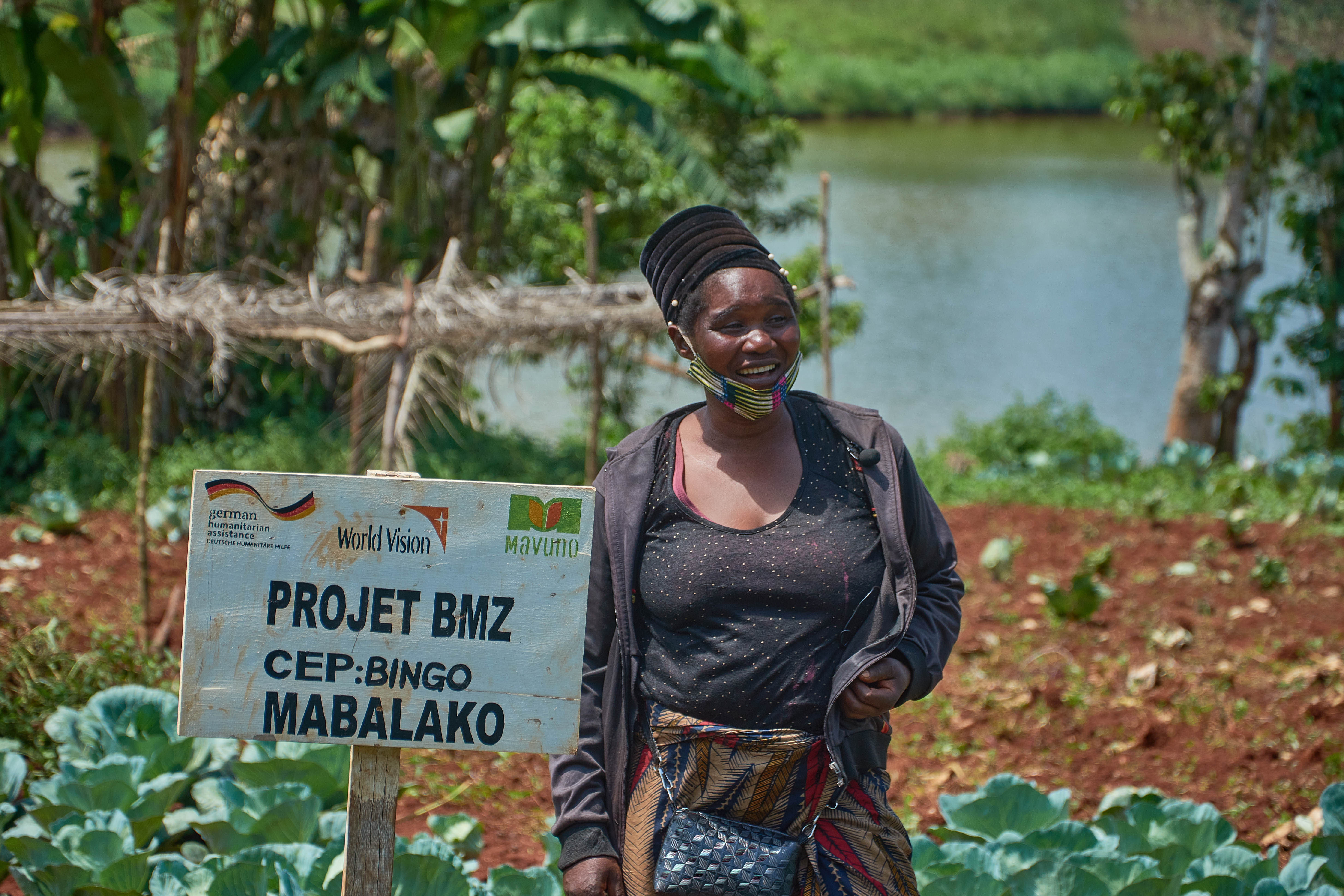 Farmer Chantal smiling in front of her cabbage farm field.