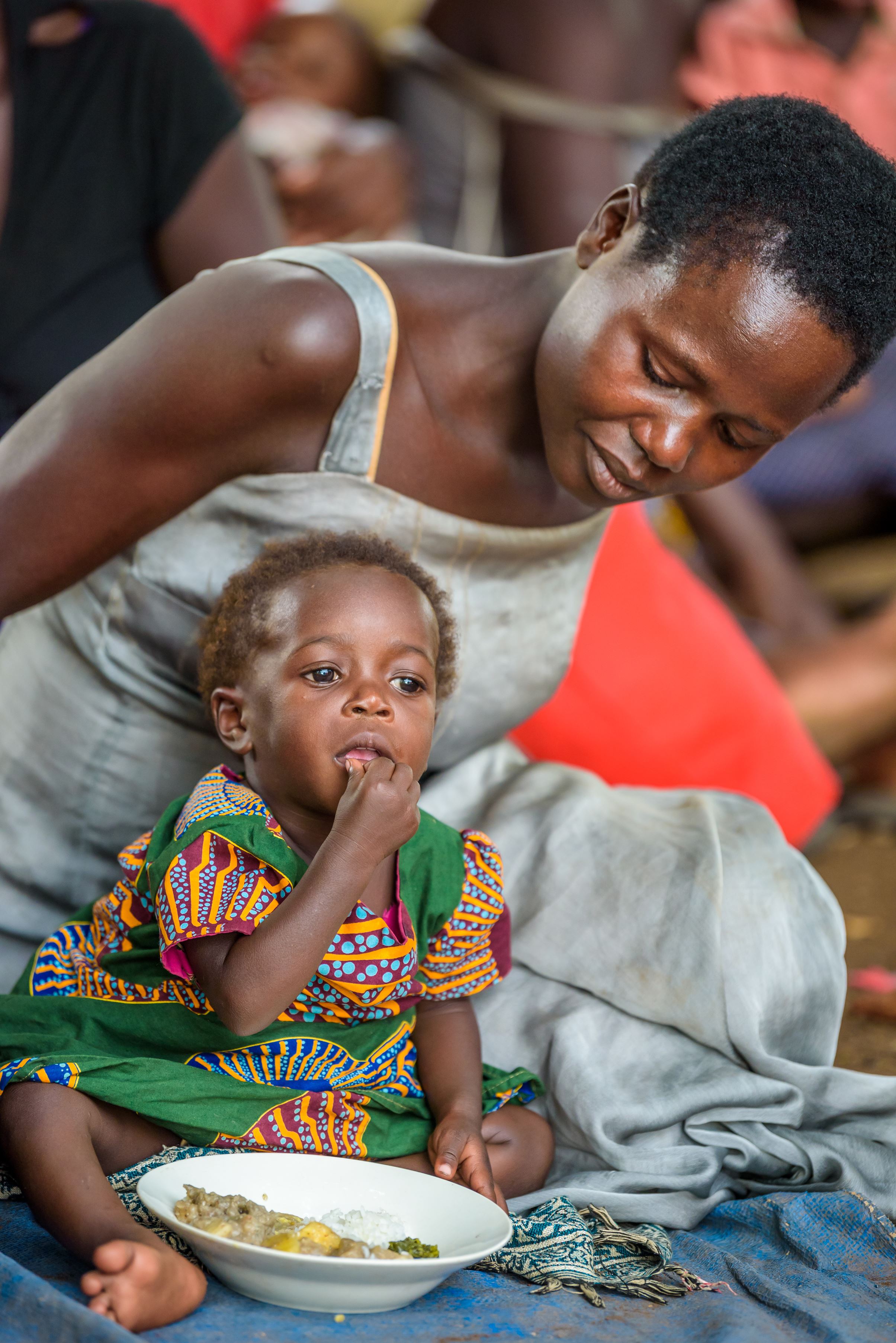 Madre y niño de uganda disfrutando su comida