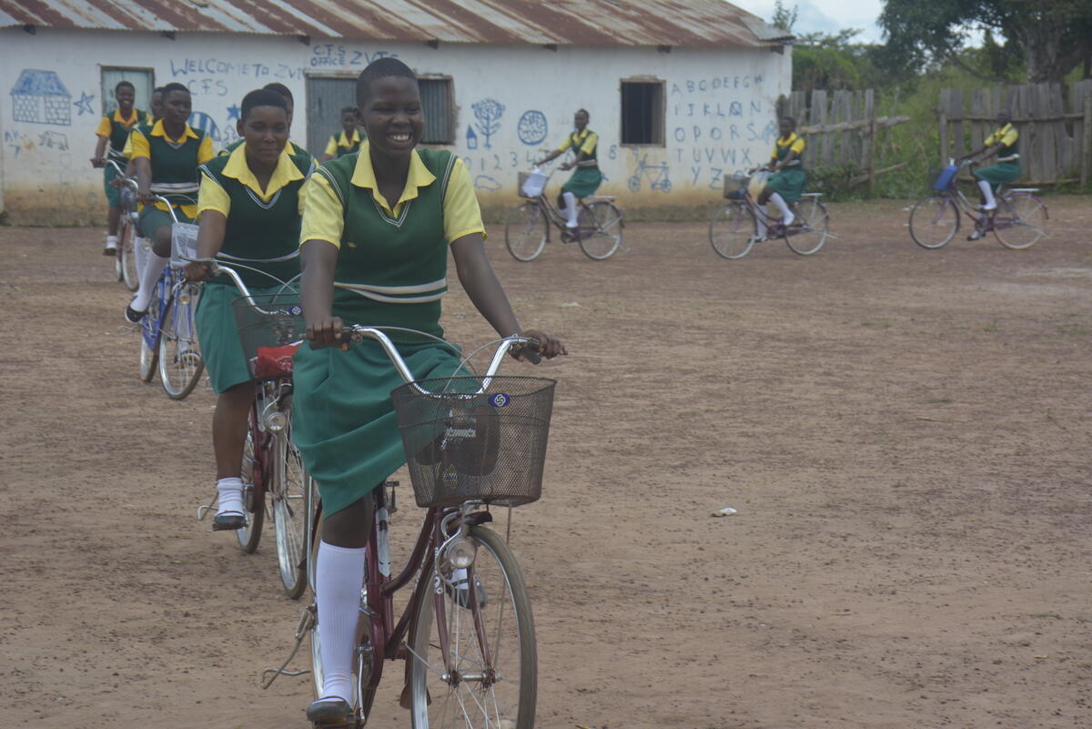 Niñas en Sudán del Sur llevando uniforme y montando en bicicleta