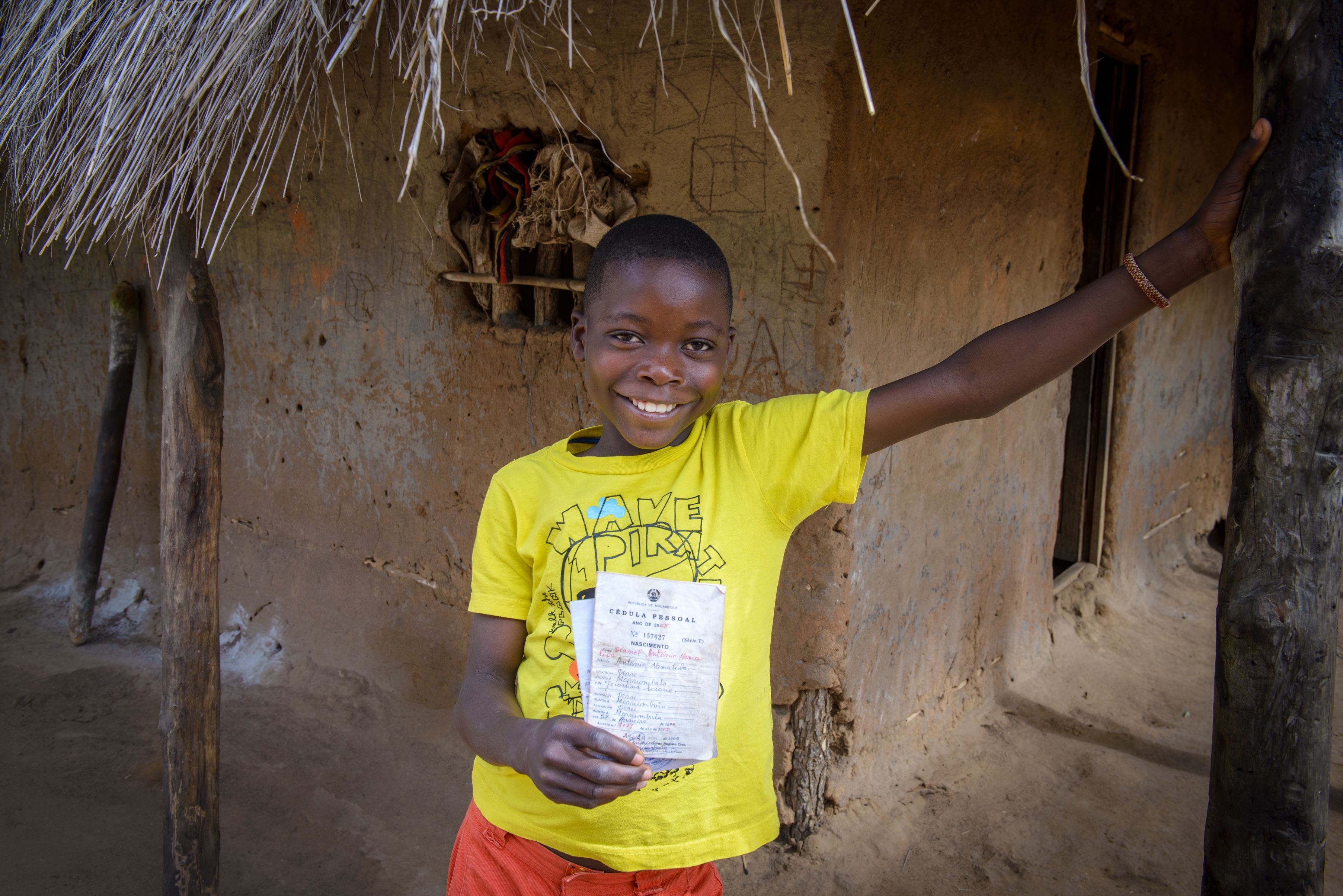 Niño en Mozambique enseña su certificado de nacimiento
