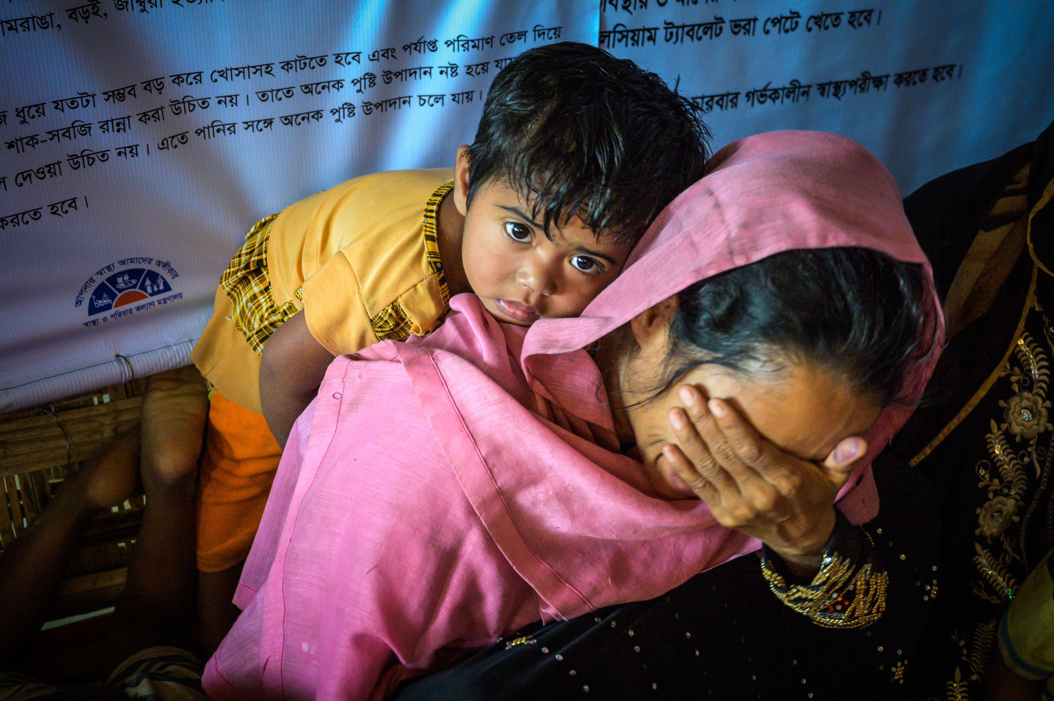 Niña en la espalda de su madre en un centro de nutrición dirigido por World Vision en un campamento de refugiados en Bangladesh